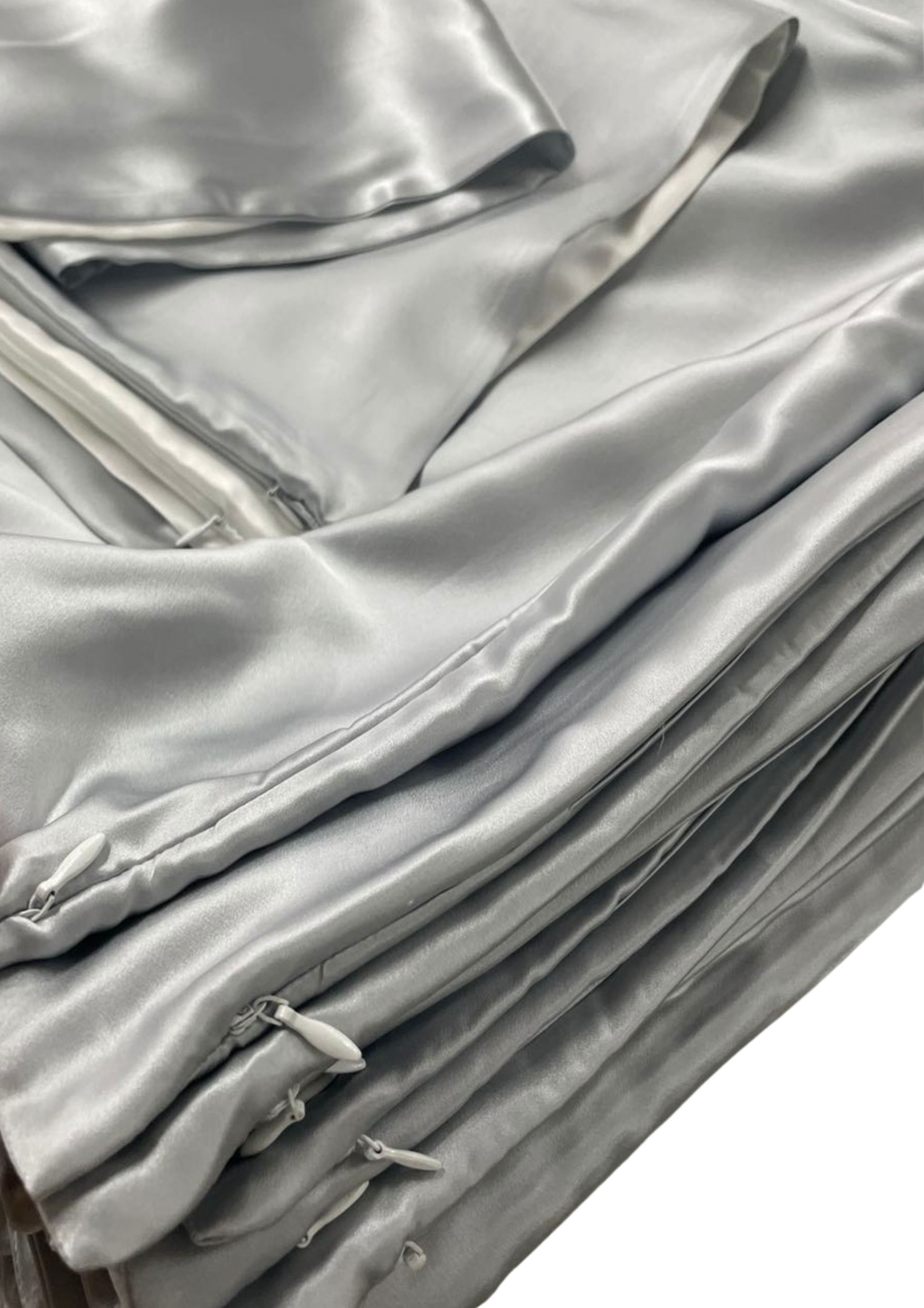 Close-up of silver silk fabric with folds, zippers