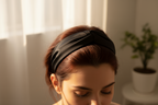 Woman wearing a black headband with a blurred background